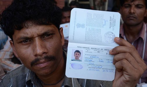 Indian-man-holding-his-passport-709732.jpg