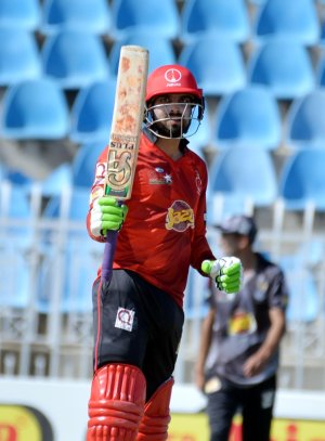 Umar Amin raises his bat after scoring hundred.JPG