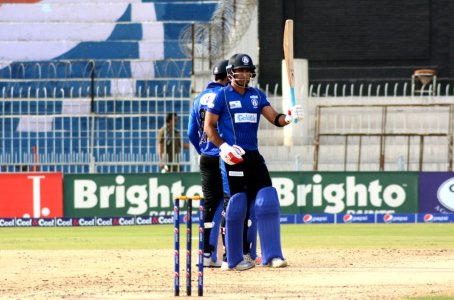 Iftikhar Ahmed raised his bat after completing hundred.JPG