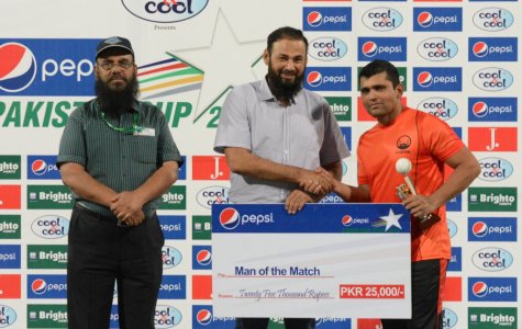 Kamran Akmal receive man of the match award from Wasim Haider.jpg