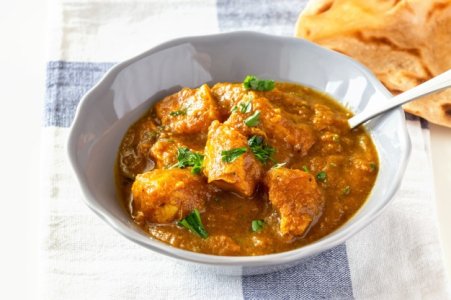 close-up-traditional-indian-butter-chicken-curry-lemon-served-with-chapati-bread-grey-plate_9027.jpg