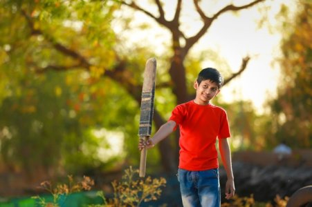 rural-indian-child-playing-cricket_75648-729.jpg