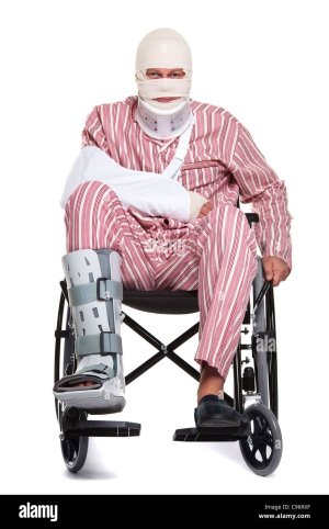 photo-of-a-man-with-various-injuries-wearing-striped-pyjames-and-sitting-C96RXF.jpg