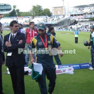 Shahid Afridi walks off the field with his medal