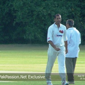 Arshad Khan walks back after bowling