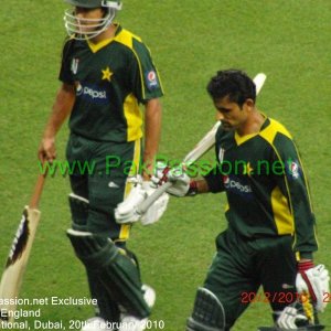 Pakistan's hero, Abdul Razzaq, raises his bat to the crowd after his match 