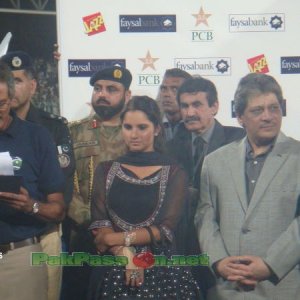 Cricket officials and Sana Mirza look on during the presentation ceremony