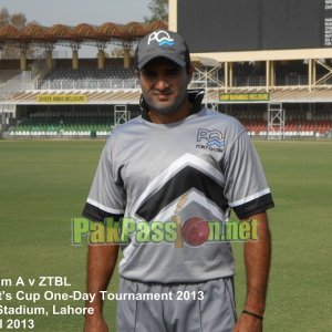 Tanvir Ahmed poses for a photo in the outfield at Gaddafi Stadium