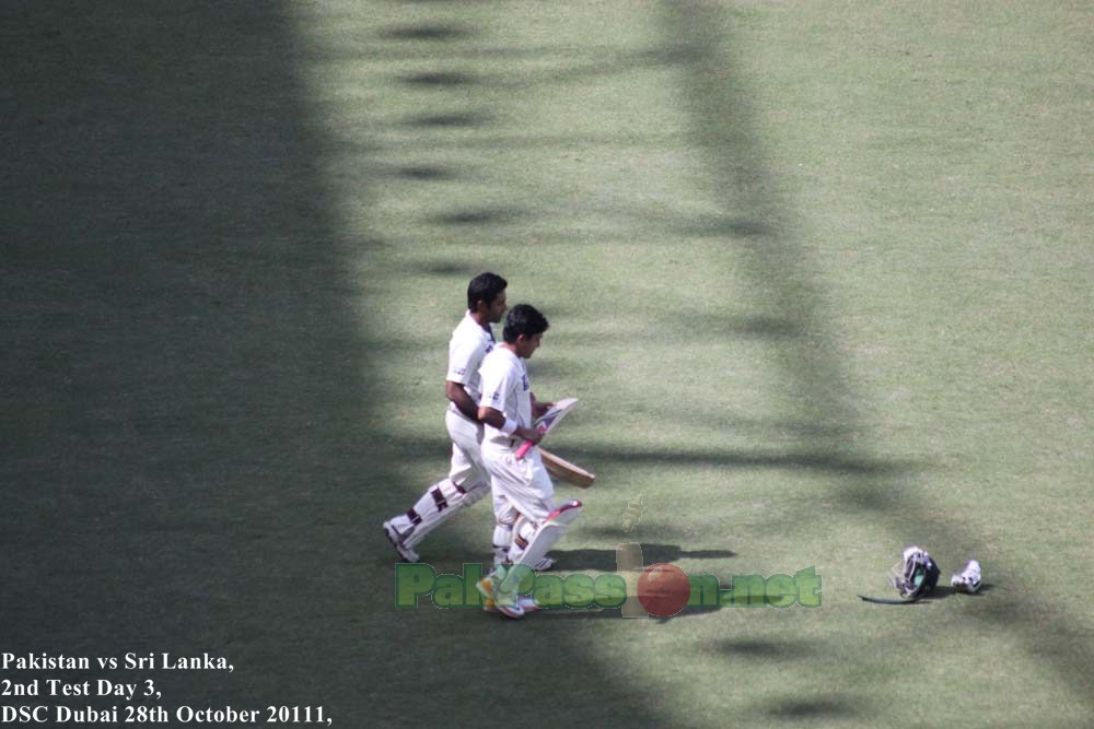 Adnan Akmal and Asad Shafiq, heading towards the pitch