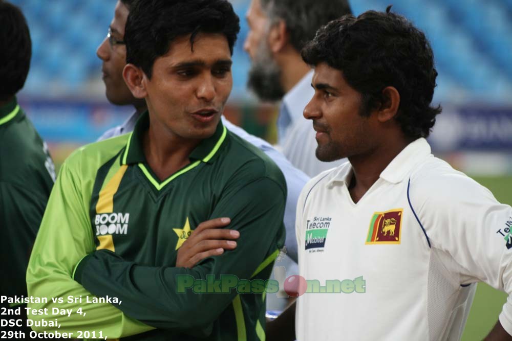 Adnan Akmal chats it up with a Sri Lankan player