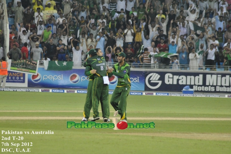 Ajmal and Hafeez celebrating after getting a wicket