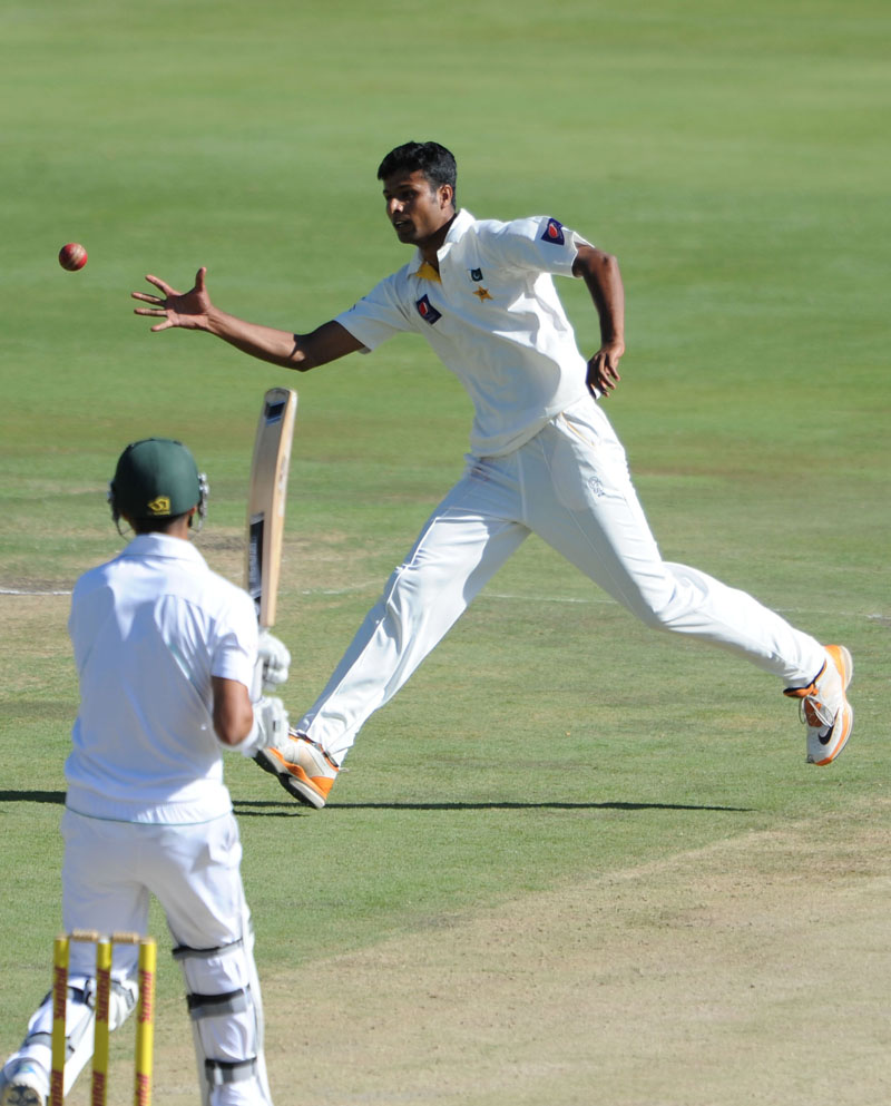 Ehsan Adil fields a ball in his follow through