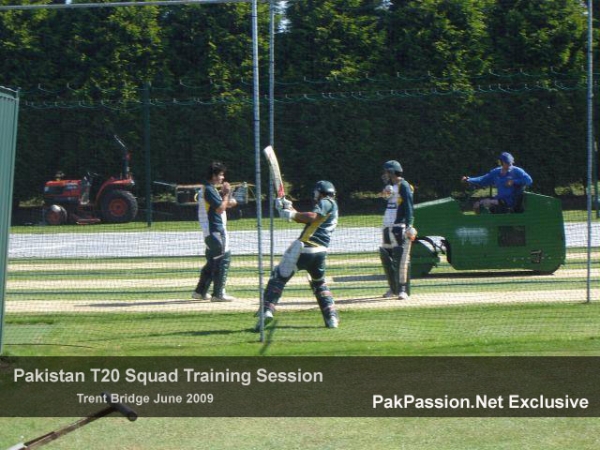 Kamran Akmal cuts a ball in the nets