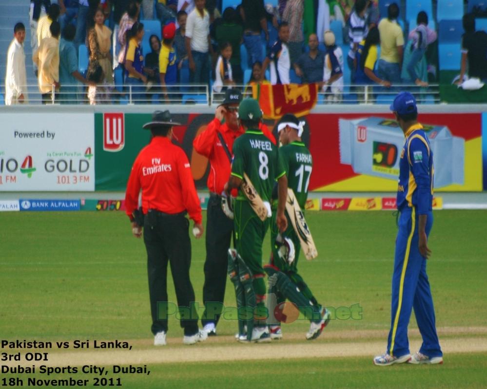 Mohammad Hafeez and Imran Farhat go up to the umpires