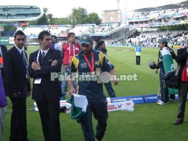 Shahid Afridi walks off the field with his medal