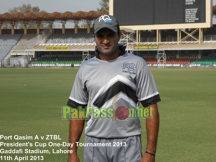 Tanvir Ahmed poses for a photo in the outfield at Gaddafi Stadium