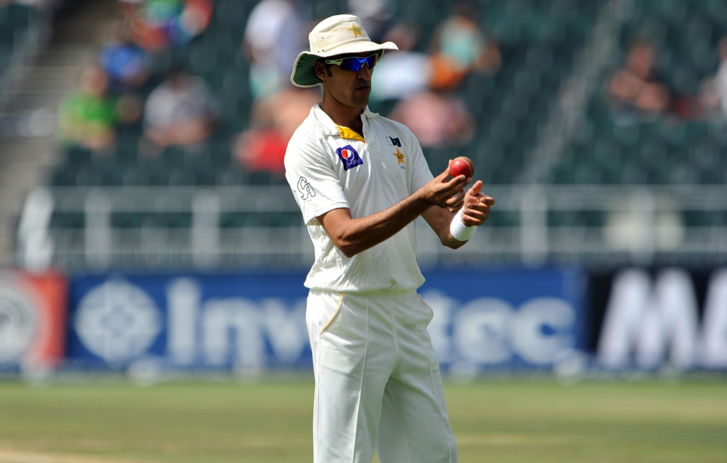 Umar Gul examines the ball very closely