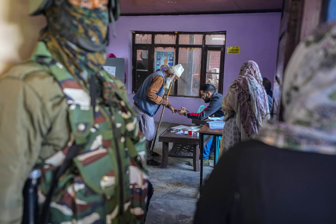 A polling official puts an ink mark on the finger of an elderly voter during the fourth phase of India's general election, on the outskirts of Srinagar, on May 13.