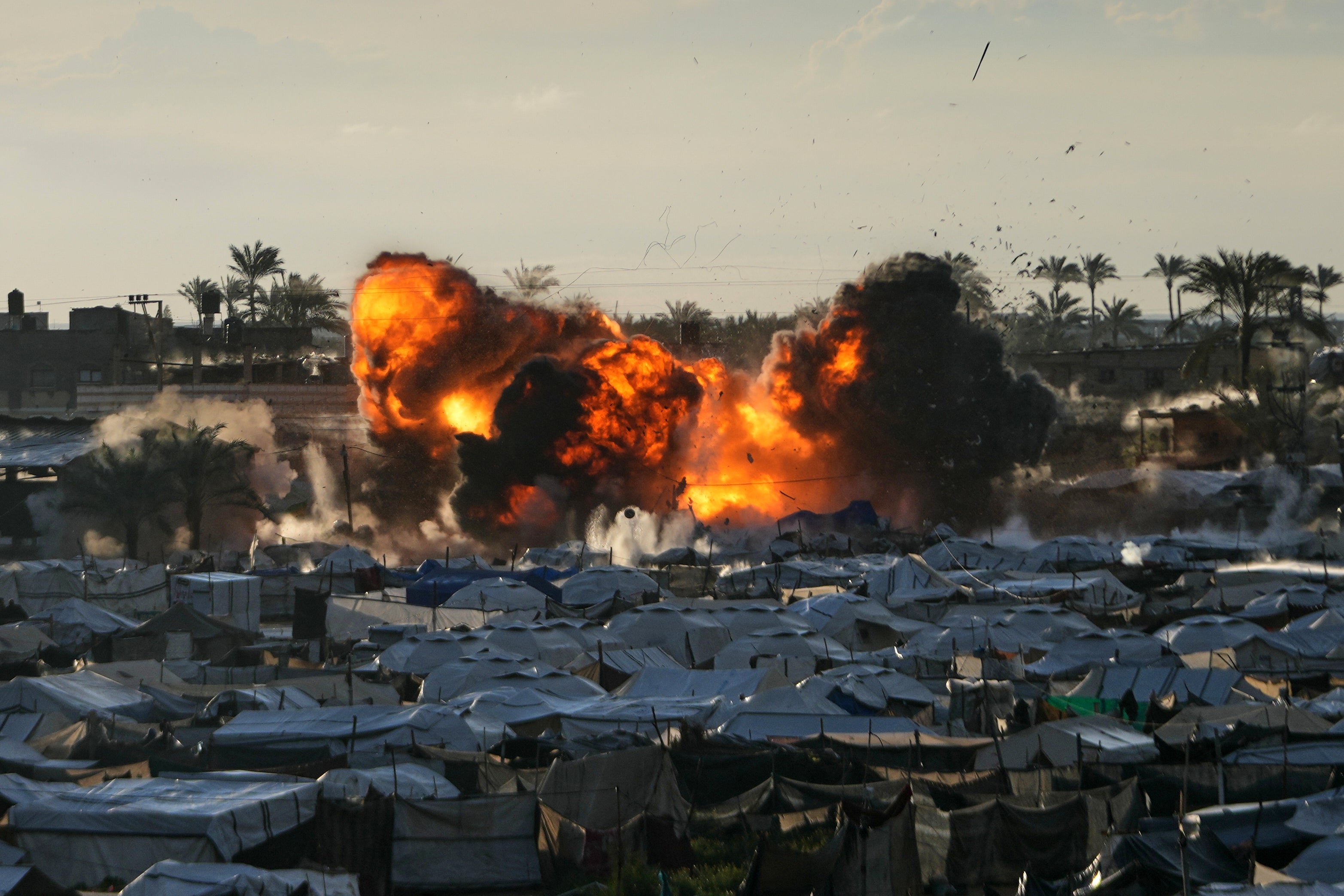 Smoke and flames rise from an Israeli military strike on a target next to a tent camp in Deir al-Balah, central Gaza Strip, March, 25, 2026