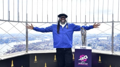 Chris Gayle at the top of the Empire State Building with the MT20WC Trophy
